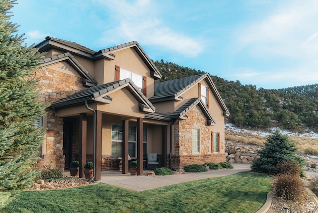 1866 N Matchstick Way, Cedar City, UT 84721 - view of home's exterior featuring stone siding, stucco siding, a lawn, and a tile roof