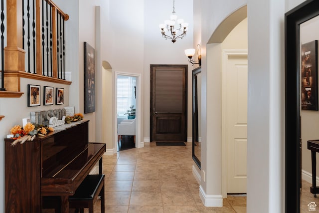 1866 N Matchstick Way, Cedar City, UT 84721 - foyer featuring arched walkways, a chandelier, a towering ceiling, baseboards, and light tile patterned floors