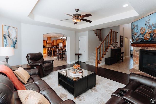 1866 N Matchstick Way, Cedar City, UT 84721 - living area featuring arched walkways, a tray ceiling, ceiling fan, stairway, and wood finished floors