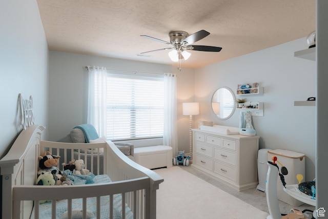 1866 N Matchstick Way, Cedar City, UT 84721 - bedroom featuring a crib, light carpet, a ceiling fan, and a textured ceiling