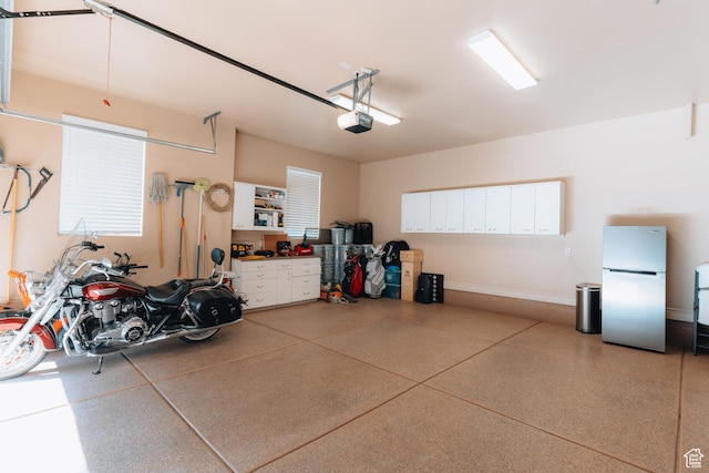 1866 N Matchstick Way, Cedar City, UT 84721 - garage featuring freestanding refrigerator, a garage door opener, and baseboards