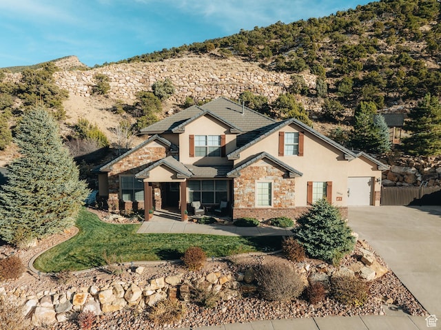 1866 N Matchstick Way, Cedar City, UT 84721 - view of front of house featuring stucco siding, driveway, stone siding, and an attached garage