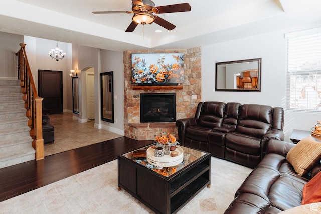 1866 N Matchstick Way, Cedar City, UT 84721 - living area with a raised ceiling, ceiling fan, stairs, light wood finished floors, and a stone fireplace