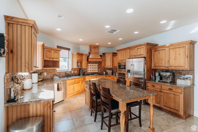 1866 N Matchstick Way, Cedar City, UT 84721 - kitchen with appliances with stainless steel finishes, a sink, tasteful backsplash, custom exhaust hood, and light stone countertops