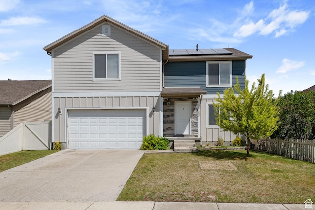traditional home with solar panels, an attached garage, board and batten siding, and driveway