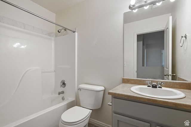 bathroom featuring toilet, vanity, and shower / washtub combination