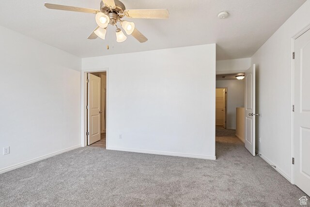 unfurnished bedroom featuring carpet, baseboards, and a ceiling fan