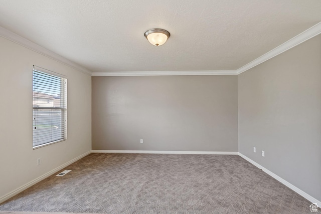 carpeted spare room with crown molding and baseboards
