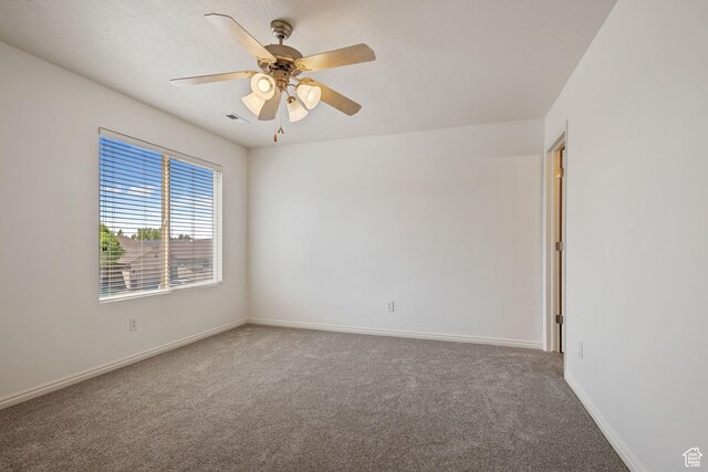 unfurnished room featuring carpet, baseboards, and ceiling fan