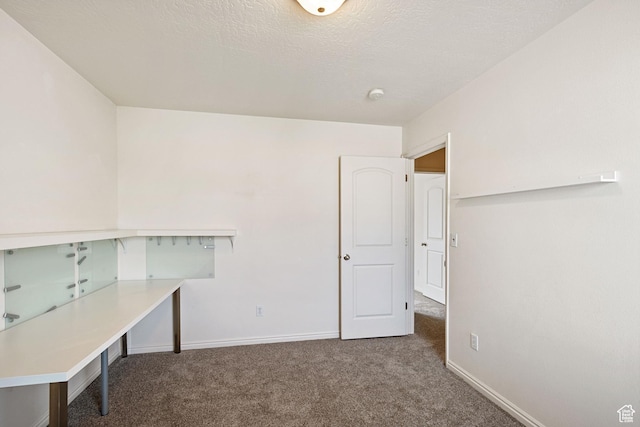 unfurnished office featuring carpet floors and baseboards