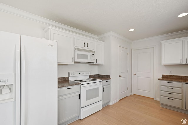 kitchen featuring white appliances, dark countertops, light wood-style flooring, ornamental molding, and recessed lighting