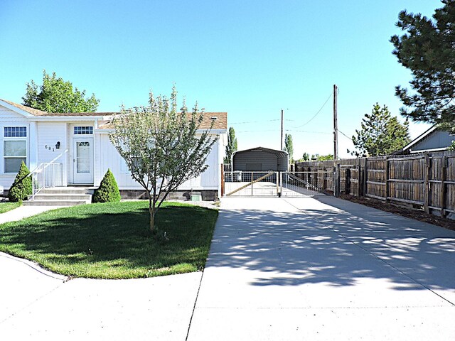 681 E Sunset St, Delta, UT 84624 - view of front of home featuring a detached carport, concrete driveway, and a gate
