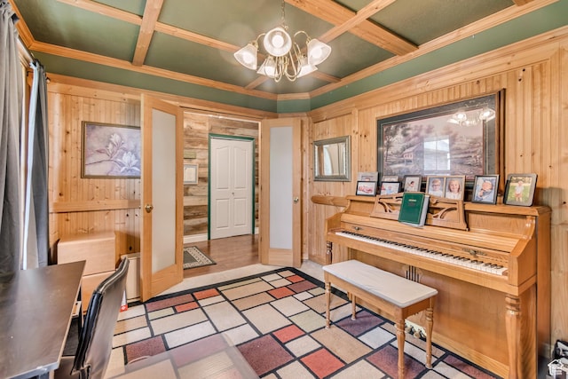 foyer featuring wood walls, coffered ceiling, a chandelier, and crown molding