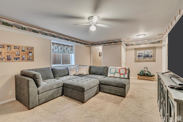 carpeted living area with a ceiling fan and baseboards