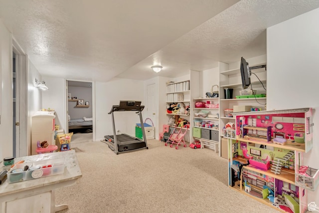 rec room featuring a textured ceiling and carpet