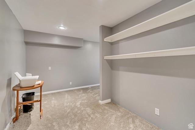 finished below grade area with carpet floors, baseboards, and recessed lighting