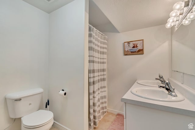 bathroom with toilet, double vanity, a shower with curtain, and baseboards