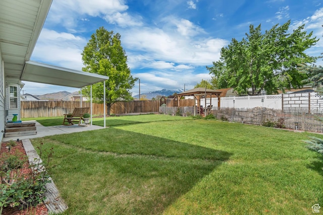 view of yard with a patio, a mountain view, and a gazebo