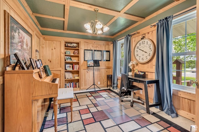office space with coffered ceiling, a chandelier, wooden walls, healthy amount of natural light, and crown molding
