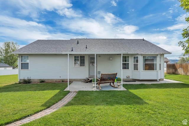 back of house featuring a patio area and a shingled roof