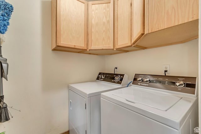 washroom featuring cabinet space and washing machine and clothes dryer