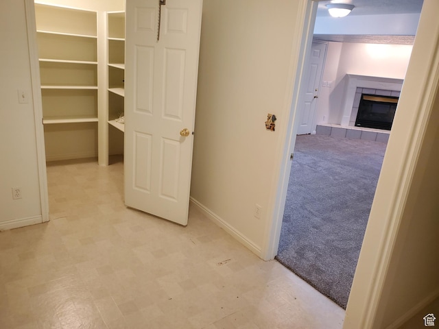 hall featuring baseboards and tile patterned floors