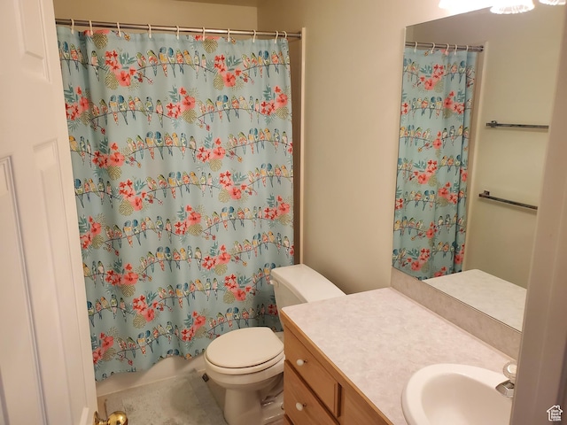 full bath featuring toilet, vanity, and tile patterned floors
