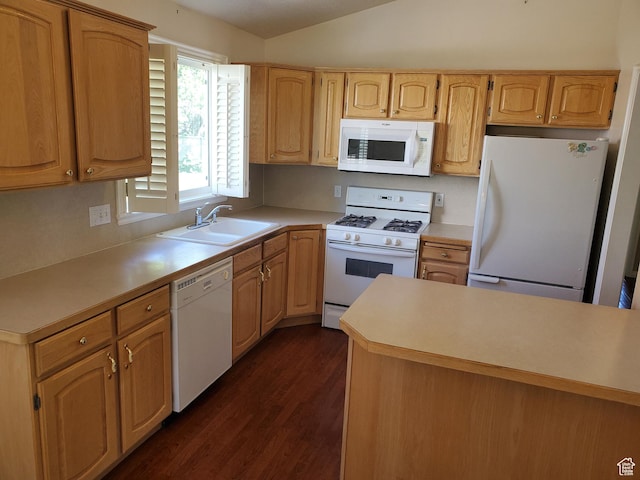 kitchen with white appliances, a sink, dark wood-style floors, vaulted ceiling, and light countertops