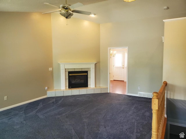 unfurnished living room featuring a ceiling fan, carpet floors, a tile fireplace, and baseboards
