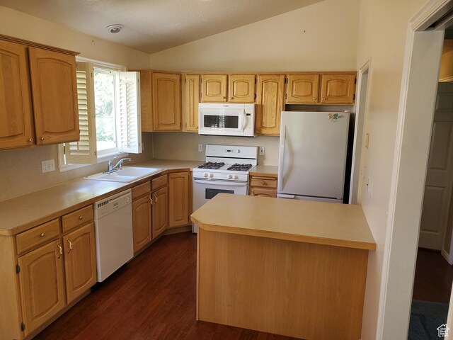 kitchen with white appliances, a sink, dark wood finished floors, lofted ceiling, and light countertops