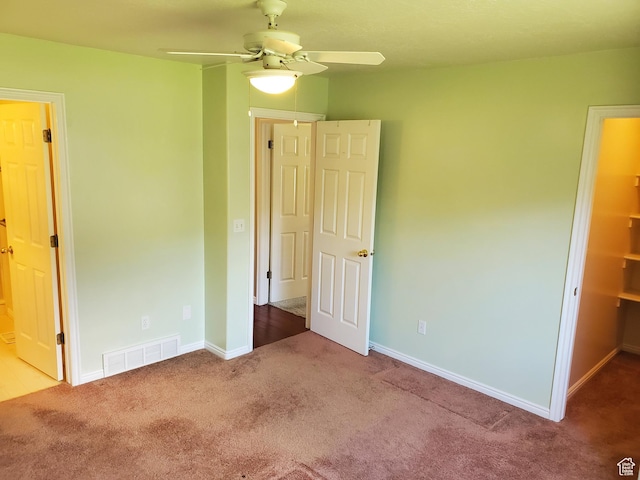 unfurnished bedroom featuring carpet floors, baseboards, and ceiling fan