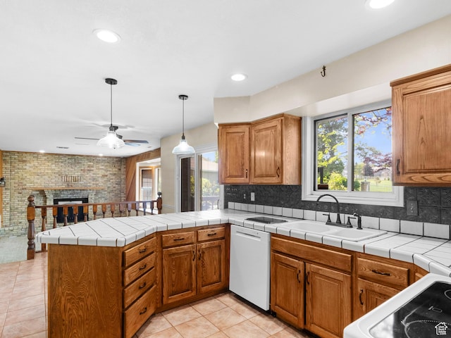 kitchen with white appliances, a sink, ceiling fan, a peninsula, and plenty of natural light