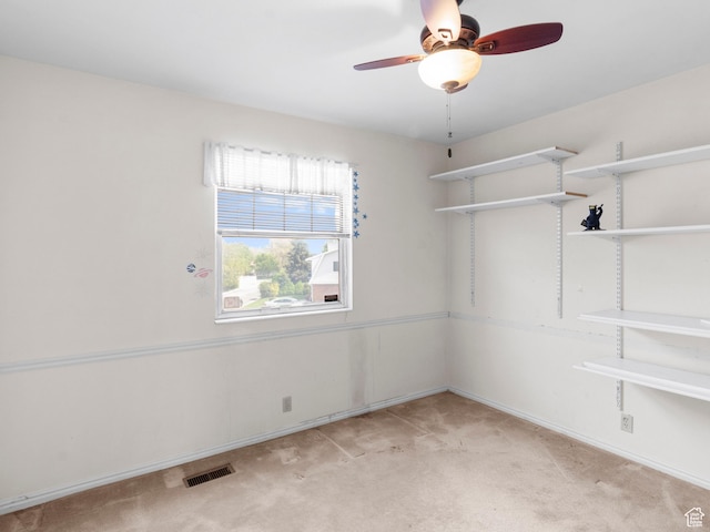 unfurnished room with light colored carpet, ceiling fan, and baseboards