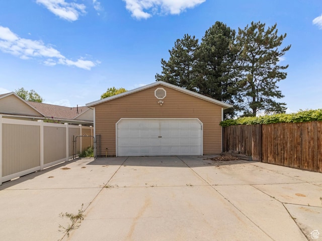detached garage featuring fence