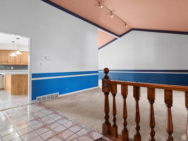stairs featuring vaulted ceiling, rail lighting, baseboards, and carpet flooring