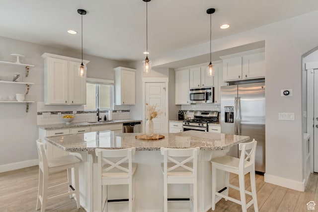 238 E Hillcrest Way N, Salt Lake, UT 84054 - kitchen with appliances with stainless steel finishes, a sink, light wood finished floors, backsplash, and baseboards