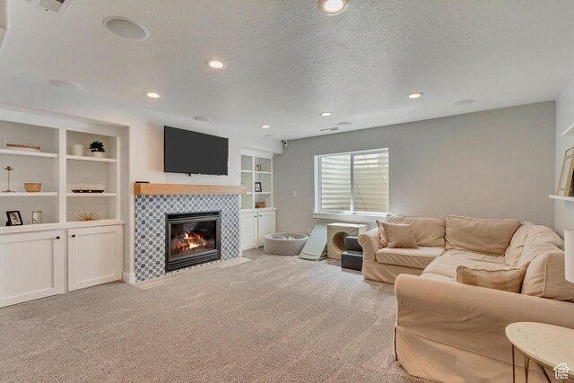 238 E Hillcrest Way N, Salt Lake, UT 84054 - living room with a tiled fireplace, light colored carpet, recessed lighting, built in features, and a textured ceiling