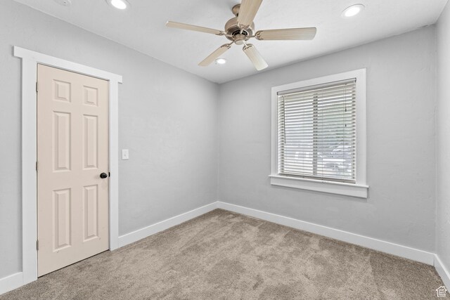 carpeted spare room with recessed lighting, baseboards, and a ceiling fan