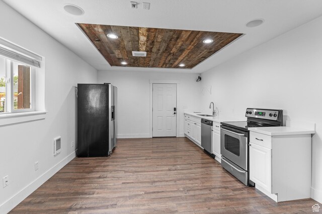 kitchen featuring appliances with stainless steel finishes, a sink, white cabinetry, light countertops, and recessed lighting