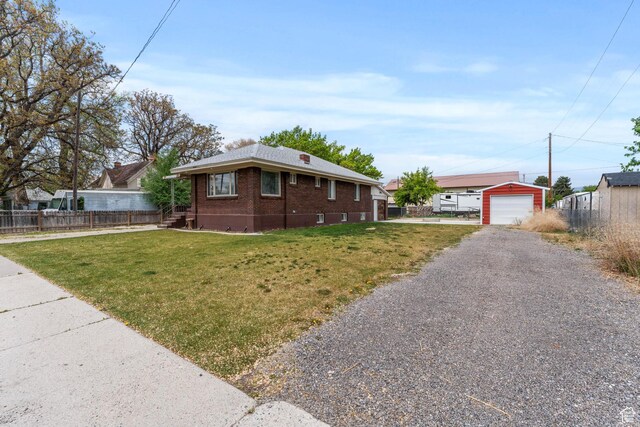 ranch-style home with gravel driveway, brick siding, and a detached garage