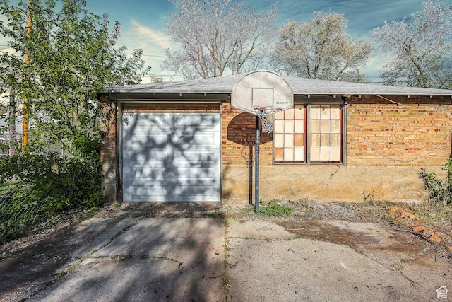 garage featuring asphalt driveway