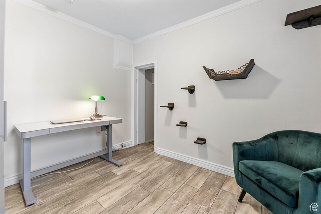 living area with ornamental molding, light wood finished floors, and baseboards