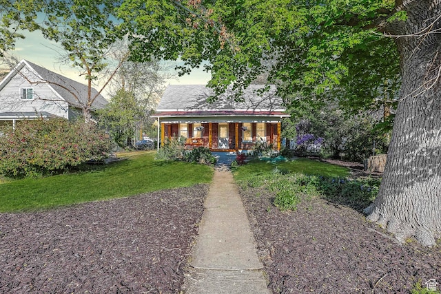 bungalow with covered porch and a front yard