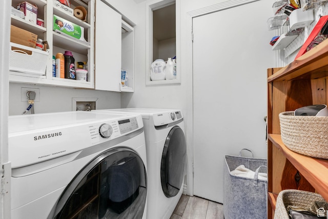 washroom with separate washer and dryer and light wood-type flooring