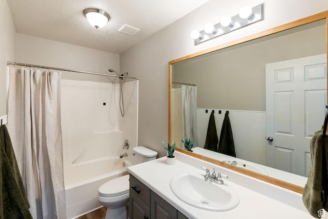 full bathroom featuring toilet, vanity, a textured ceiling, shower / bath combo, and wood finished floors