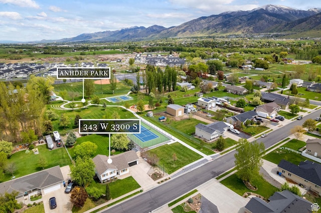 aerial perspective of suburban area with property parcel outlined and a mountainous background