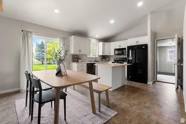 kitchen featuring black appliances, a center island, white cabinets, light countertops, and recessed lighting