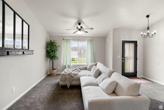 carpeted living room featuring a chandelier, ceiling fan, and baseboards