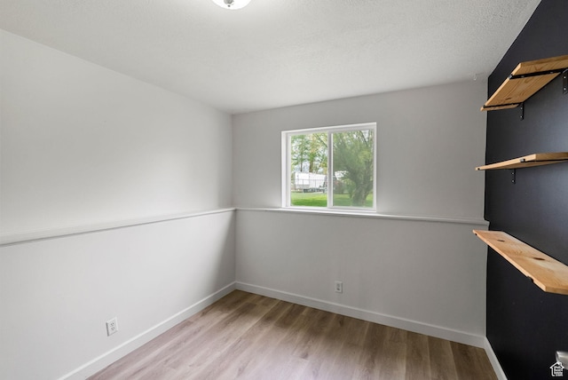 empty room with wood finished floors and baseboards