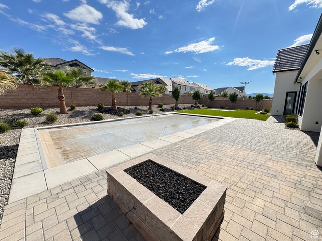 view of pool featuring a fenced backyard, a patio area, and a residential view